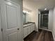 Modern bathroom with dual sinks, granite countertop, and a glass-enclosed shower at 115 Heyman Dr, Covington, GA 30016