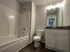 Clean bathroom with a tub and shower combination and granite countertop at 115 Heyman Dr, Covington, GA 30016