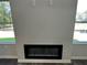Close-up of a contemporary fireplace with a sleek black finish, creating a cozy focal point in the living space at 115 Heyman Dr, Covington, GA 30016