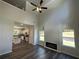 Spacious living room featuring high ceilings, a modern fireplace, and dark wood floors, blending comfort and style at 115 Heyman Dr, Covington, GA 30016