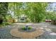 Spacious backyard with patio, gravel, and mature trees at 1311 Sylvan Cir, Brookhaven, GA 30319