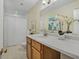 Bright bathroom with large mirror, white countertop, and wooden cabinets, complemented by stylish decor at 1311 Sylvan Cir, Brookhaven, GA 30319