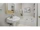 Bathroom features a pedestal sink, soaking tub, and built-in shelving for added storage at 1311 Sylvan Cir, Brookhaven, GA 30319