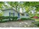 Charming single-story home with blue door, surrounded by mature trees and greenery at 1311 Sylvan Cir, Brookhaven, GA 30319
