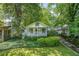 Charming bungalow with a covered front porch and lush, mature landscaping at 1311 Sylvan Cir, Brookhaven, GA 30319