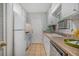 Functional galley kitchen with white cabinets, updated appliances, and laminate countertops at 1311 Sylvan Cir, Brookhaven, GA 30319
