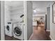 Laundry room features washer and dryer; in view are the kitchen and dining area at 1311 Sylvan Cir, Brookhaven, GA 30319