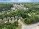 Wide aerial shot of a lush, tree-filled suburban neighborhood featuring well-manicured lawns and sidewalks at 1537 Maplecliff Way, Sugar Hill, GA 30518
