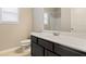 Stylish bathroom featuring a dark vanity and shower with a tub at 1537 Maplecliff Way, Sugar Hill, GA 30518