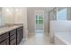This bathroom offers a double vanity, a shower, and a tub for relaxation and convenience at 1537 Maplecliff Way, Sugar Hill, GA 30518