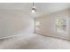 Spacious carpeted bedroom features a fan and two windows for natural light and ventilation at 1537 Maplecliff Way, Sugar Hill, GA 30518
