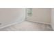 Neutral carpeted bedroom features a window that brightens the room with natural light at 1537 Maplecliff Way, Sugar Hill, GA 30518