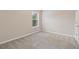Cozy bedroom featuring carpeted floors and a window with natural light at 1537 Maplecliff Way, Sugar Hill, GA 30518