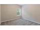 Neutral bedroom with carpeted floors and a window with natural light at 1537 Maplecliff Way, Sugar Hill, GA 30518