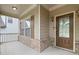 Charming covered front porch with brick accents and classic detailing, leading to the front door at 1537 Maplecliff Way, Sugar Hill, GA 30518