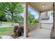 Inviting front porch with classic white columns and railings, offering a relaxing outdoor space at 1537 Maplecliff Way, Sugar Hill, GA 30518