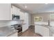 Well-equipped kitchen with stainless steel appliances, granite counters, and white cabinetry for a clean, modern look at 1537 Maplecliff Way, Sugar Hill, GA 30518