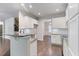 Modern kitchen with white cabinets, granite countertops, stainless steel appliances, and an open layout at 1537 Maplecliff Way, Sugar Hill, GA 30518