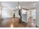 Bright living room featuring hardwood floors, an open floor plan, and staircase access at 1537 Maplecliff Way, Sugar Hill, GA 30518