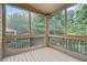 Inviting screened porch overlooking lush greenery, perfect for relaxation at 1537 Maplecliff Way, Sugar Hill, GA 30518