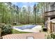 Beautiful backyard with a covered pool, mature trees, and a charming fence creating a private oasis at 1772 Brittany Chase Nw, Kennesaw, GA 30152