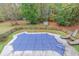 Aerial view of a beautiful fenced backyard featuring a covered swimming pool surrounded by mature trees at 1772 Brittany Chase Nw, Kennesaw, GA 30152