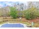 Aerial view of a beautiful fenced backyard featuring a covered swimming pool surrounded by mature trees at 1772 Brittany Chase Nw, Kennesaw, GA 30152