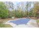 Backyard featuring a covered swimming pool with lounge chairs, surrounded by a fence and mature trees at 1772 Brittany Chase Nw, Kennesaw, GA 30152