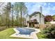 Backyard featuring a covered pool area, deck, and a well-maintained lawn at 1772 Brittany Chase Nw, Kennesaw, GA 30152