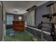 Finished basement area with an office nook, exercise equipment, and carpet flooring at 1772 Brittany Chase Nw, Kennesaw, GA 30152
