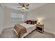 Bright bedroom featuring carpet floors, ceiling fan, and a window with natural light at 1772 Brittany Chase Nw, Kennesaw, GA 30152