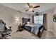 Well-lit bedroom with ceiling fan, carpet floors, and a window with natural light at 1772 Brittany Chase Nw, Kennesaw, GA 30152