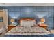 Bedroom boasts stylish paneled wall, two side tables and lamps and comfy bed at 1772 Brittany Chase Nw, Kennesaw, GA 30152