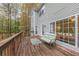 Back deck with wooded view, outdoor seating, and access to house through sliding door at 1772 Brittany Chase Nw, Kennesaw, GA 30152
