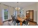Bright dining room with hardwood floors, six chairs, and a modern light fixture at 1772 Brittany Chase Nw, Kennesaw, GA 30152