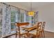 Dining room with natural wood table and views to living room and large windows at 1772 Brittany Chase Nw, Kennesaw, GA 30152