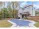 Rear exterior of a home with a large covered pool, deck, patio, and a fenced backyard surrounded by trees at 1772 Brittany Chase Nw, Kennesaw, GA 30152