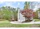 Rear exterior view of two-story home featuring a two-car garage, siding, and landscaping at 1772 Brittany Chase Nw, Kennesaw, GA 30152