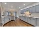 Open kitchen with gray cabinets, stainless steel appliances, and dining area view at 1772 Brittany Chase Nw, Kennesaw, GA 30152