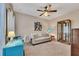 Cozy living room with neutral walls and carpet features a ceiling fan and comfortable furniture at 1772 Brittany Chase Nw, Kennesaw, GA 30152