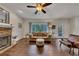 Inviting living room with stone fireplace, hardwood floors, and abundant natural light at 1772 Brittany Chase Nw, Kennesaw, GA 30152