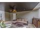 Covered patio area with a ceiling fan and comfortable seating, perfect for outdoor relaxation and entertaining at 1772 Brittany Chase Nw, Kennesaw, GA 30152