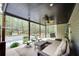 Covered porch with outdoor seating and a view of the backyard and wooded area at 1772 Brittany Chase Nw, Kennesaw, GA 30152
