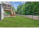 Large grassy backyard with privacy fence and deck at 1450 Rainfall Ct, Cumming, GA 30040