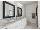 Elegant bathroom with double sinks, granite countertops, and decorative mirrors at 1450 Rainfall Ct, Cumming, GA 30040
