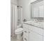 Bright bathroom features a tub and shower, granite countertop, and white cabinets at 1450 Rainfall Ct, Cumming, GA 30040