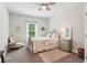 Cozy bedroom with neutral decor, a soft rug, and a comfortable-looking bed at 1450 Rainfall Ct, Cumming, GA 30040