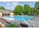 A community pool with lounge chairs and umbrellas available to residents at 1450 Rainfall Ct, Cumming, GA 30040