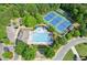 Aerial view of the community pool and tennis courts surrounded by trees at 1450 Rainfall Ct, Cumming, GA 30040