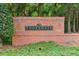 The ThornGate brick community welcome sign is surrounded by greenery at 1450 Rainfall Ct, Cumming, GA 30040